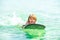 Summer vacation. Child with surf board. Summertime. Smiling boy swimming.