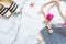 Summer vacation composition. Elegant sandals, striped beach bag, seashells, sea star, water bottle on marble background. Women`s