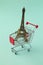 Summer vacation concept. Eiffel Tower souvenir inside shopping cart