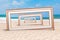 Summer Vacation Concept. Infinity View Through Wooden Vintage Frame on an Ocean Deserted Coast. 3d Rendering