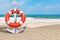 Summer Vacation Concept. Silver Nautical Anchor with Lifebuoy on an Ocean Deserted Coast. 3d Rendering