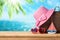 Summer vacation concept with suitcase, sunglasses, hat and boat