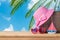 Summer vacation concept with suitcase, sunglasses, hat and boat over sea beach background