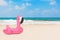 Summer Vacation Concept. Summer Swimming Pool Inflantable Rubber Pink Flamingo Toy on an Ocean Deserted Coast. 3d Rendering
