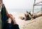 Summer vacation concept. Unrecognizable womans legs in hammock on beach against background of sea. Happiness, tourism, relaxation