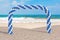 Summer Vacation Concept. White and Blue Balloons in Shape of Arc, Gate or Portal on an Ocean Deserted Coast. 3d Rendering