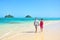 Summer vacation couple walking on Hawaii beach