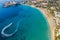 Summer vacation in Cyprus island. Aerial view of bay with jet ski rides on sea surface leaving white trail of foam and