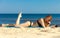 Summer vacation Girl with phone tanning on beach