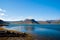 Summer vacation in isafjordur, iceland. Hilly coastline on sunny blue sky. Mountain landscape seen from sea. Discover