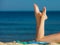 Summer vacation. Legs of sunbathing girl on beach