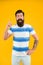 Summer vacation. Man bearded hipster with mustache and long beard on yellow background. Guy dressed striped shirt on