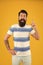 Summer vacation. Man bearded hipster with mustache and long beard on yellow background. Guy dressed striped shirt on