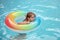 Summer vacation. Summertime childs weekend. Boy in swiming pool with inflatable rubber circle.