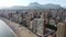 summer vacation and travel concept - aerial view of beach promenade, mountains and scyscrapers in Benidorm, Spain