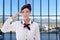 Summer, vacation and travel concept - young stewardess posing in airport