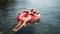 Summer vacation woman in hat floats on an inflatable donut mattress. Happy woman relaxing and enjoying family summer