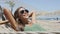 Summer vacation woman lying down on beach hammock relaxing putting sunglasses