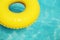 Summer vacation Yellow swimming ring on blue water.