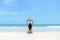 Summer Vacations. Asian Woman sitting on the sandy beach looking at the sea and sky