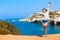 Summer vacations. Girl with hands up near the sea.