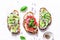 Summer variations of sandwiches - with cream cheese, avocado, tomato and cucumber on a light background, top view. Healthy diet fo