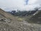 Summer view of alpine mountain valley with winding stream and glacial lake, Sulzenauferner Glacier, Stubai Alps, Austria