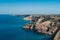 Summer view on cape in the sea, clear azure water, cliff, calm hot day