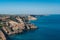 Summer view on cape in the sea, clear azure water, cliff, calm hot day