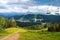 Summer view of Carpathian Mountains landscape in Bukovel, Ukraine. Green forests, hills, grassy meadows and blue sky