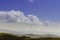 Summer view of Carpathian Mountains and Valleys, under blue sky with clouds. With pair of paragliders in sky.