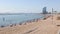 Summer view of lively popular Barceloneta beach with sail shaped luxury hotel W Barcelona rising in background on sunny