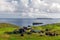 Summer view of small village with typical faroese turf-top houses