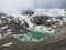 Summer view of the Sulzenauferner Glacier and turquoise glacial lake and waterfall from melting ice. Stubai Alps