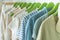 Summer wardrobe with linnen clothes on green hangers