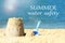 Summer water safety. View of beach with sand figure and shovel near sea