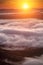 Summer weather phenomenon. Seasonal landscape with morning fog in valley. Clouds drenched valley below the level of the mountains.