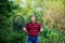 Summer weekend concept. Fishing day. Handsome guy in checkered shirt with fishing equipment nature background. Fishing