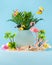 Summer weekend party concept. Flamingo, toucan, palms, tropical flowers and beach accessories on blue background