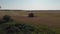 Summer wheat harvesting. Working rye harvester combine machines on gold wheat fields. Rye corn harvesters on gold wheat