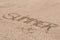 Summer written in soft wet sand on a beach, Dubai-1 September 2017