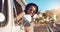 Summers here. Lets go. a happy young woman leaning out of the window during a road trip.