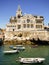 Summertime in Cascais - Fishing gear and boats with Seixas Palace in the background