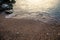 Summertime evening sand and pebbles of the Aponissos beach, Agistri island, Saronic gulf, Greece.