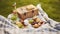 Summertime Feast, Captivating Close-up of Food, Drinks, and a Picnic Basket on a Grassy Blanket, Setting the Perfect Park Picnic