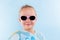 Summertime. Girl with ball and sunglasses isolated.