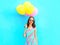 Summertime! happy smiling woman holds in hand an air colorful balloons