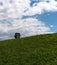 A summertime meadow with an empty cable railway cabin