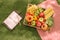 Summertime picnic setting on the grass with open picnic basket, fruit, salad and cherry pie