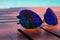 Summertime. Style glasses with palm reflection which located on a wooden table on the coast of the Caribbean Sea